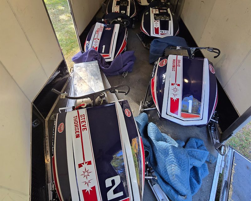 Vintage Polaris team race sleds padded and loaded in the enclosed trailer