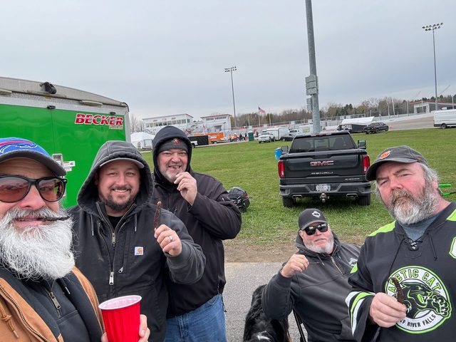 Adam (second from left) and friends in the pits at a race weekend